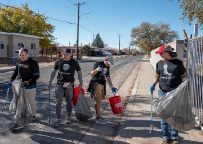 Team members cleaning up the community